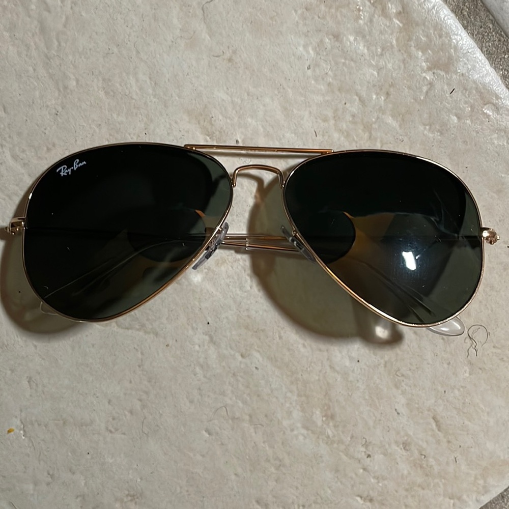 Gold Rayban glasses . Aviator style